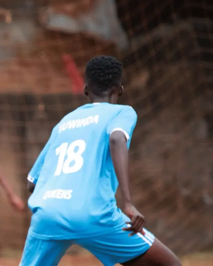 A player in blue carrying the ball forward
