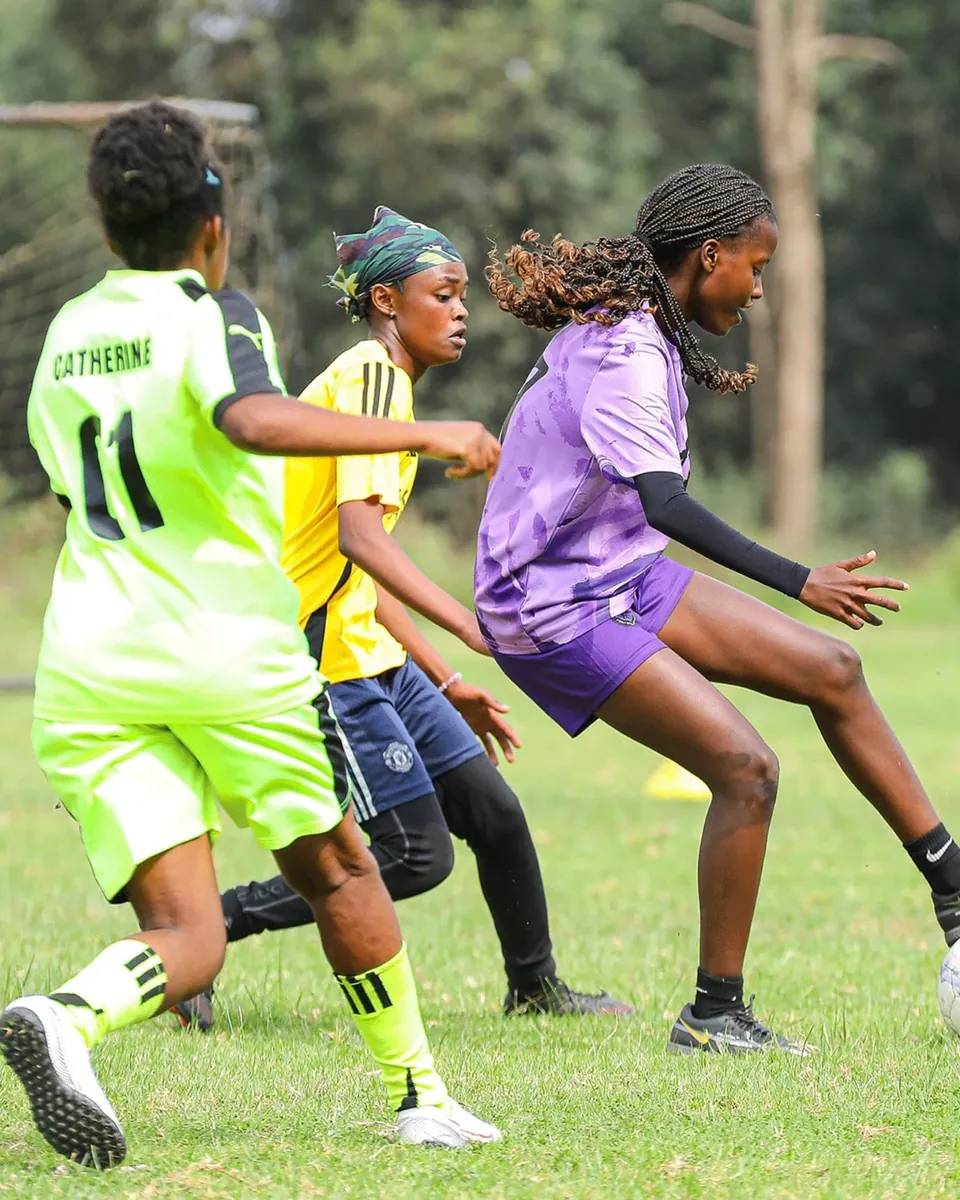 Two players stretching for the same ball