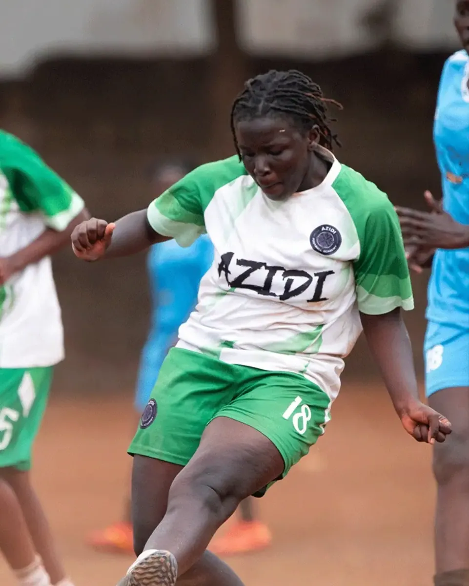A player in the green and white kit shooting